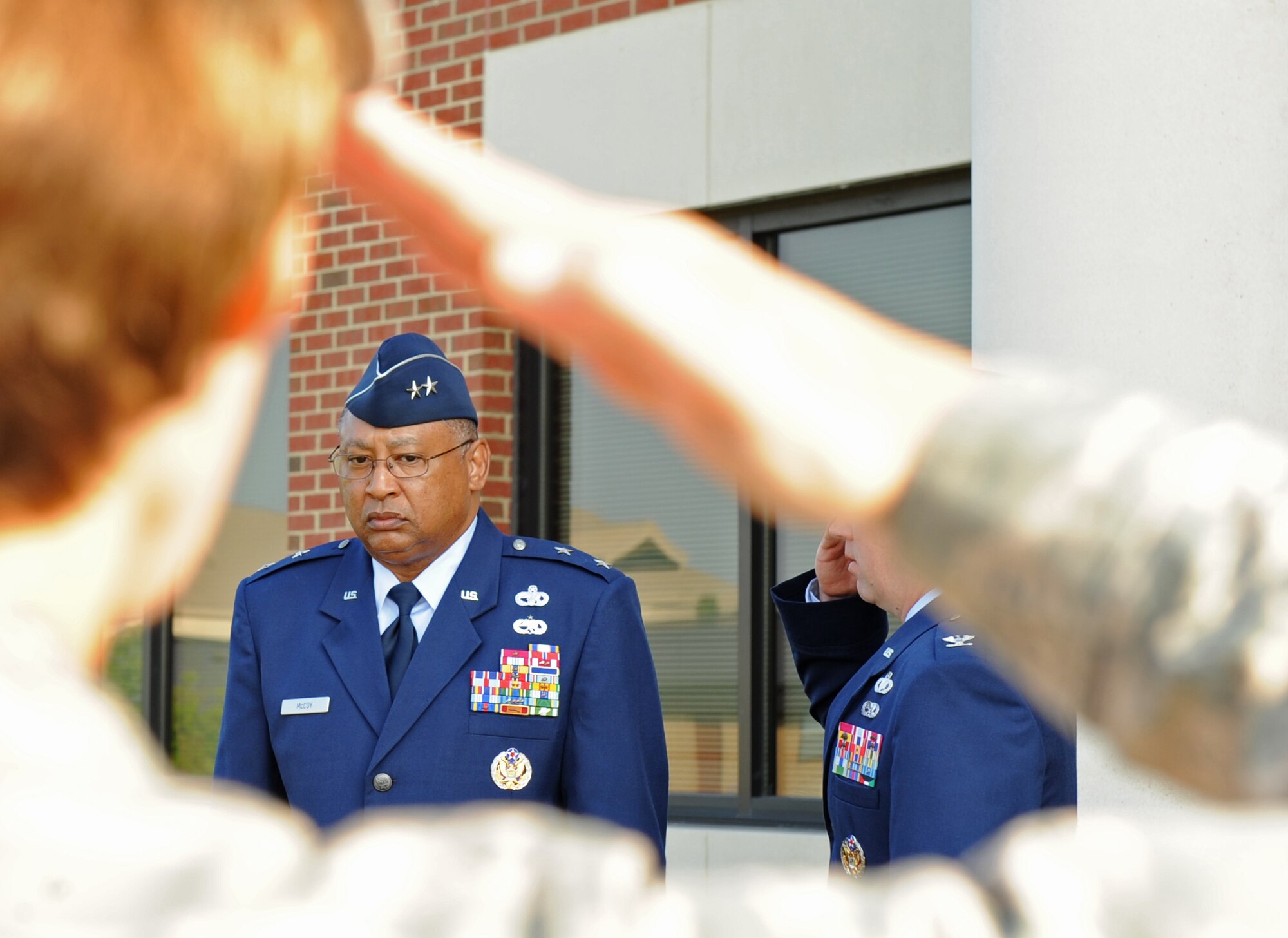 LANGLEY AIR FORCE BASE, Va. -- Maj. Gen. Gary T. McCoy, Air Force Global Logistics Support Center commander, is saluted during the playing of Ruffles and Flourishes at the ribbon-cutting ceremony for the new 735th Supply Chain Management Group building here June 26. The new building was built to accommodate more employees and improve working conditions for 735th SCMG personnel.  (U.S. Air Force photo/Airman 1st Class Jonathan Koob)