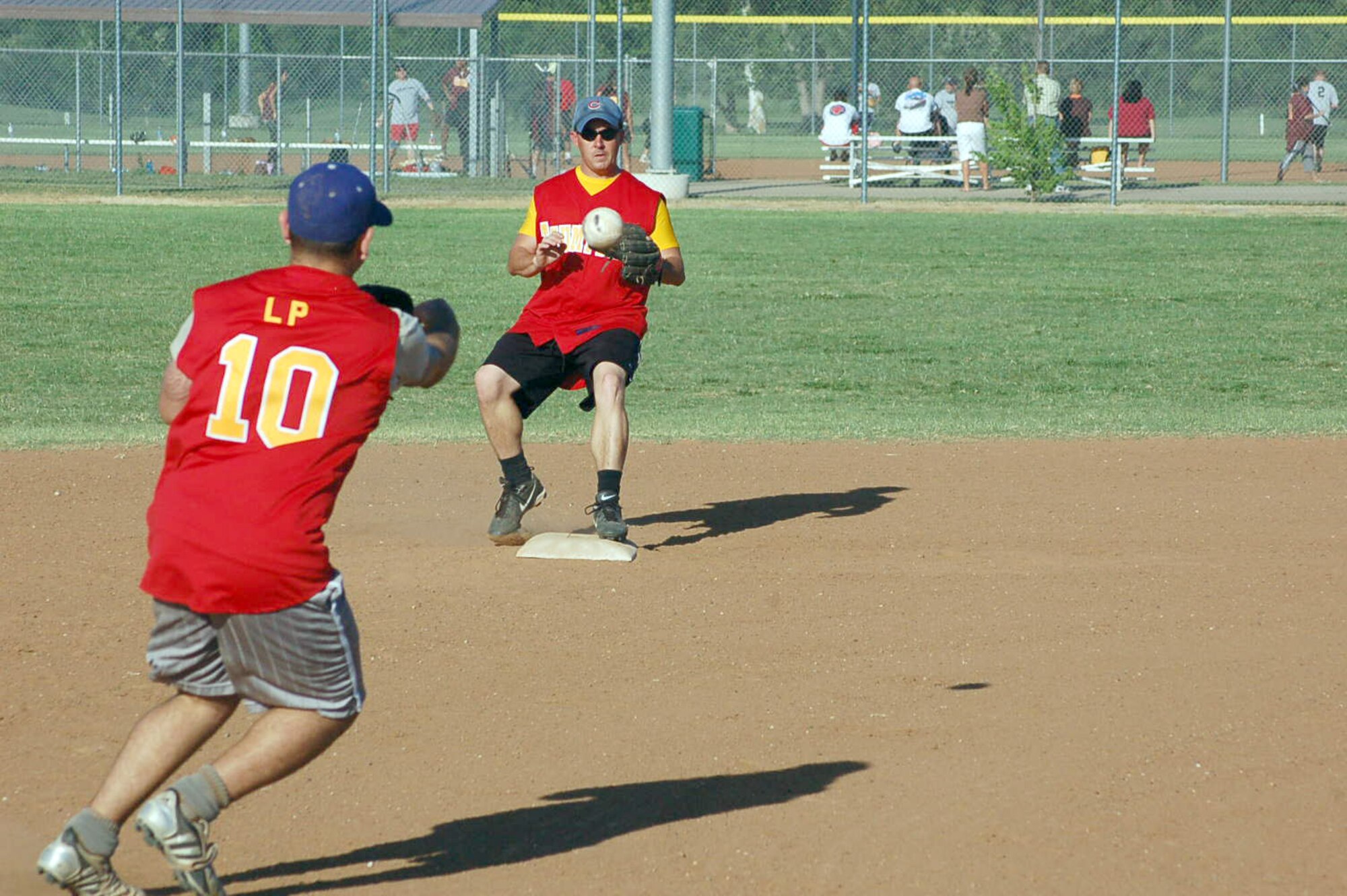 Thumper third baseman Erick Reynoso-Gonzales and second baseman Dan Gibb complete a double play during the a game versus the Okies at the Tinker Sports Complex Field 1 on June 18. The Thumpers won the game 14-6. (Air Force photo by John E. Banks)