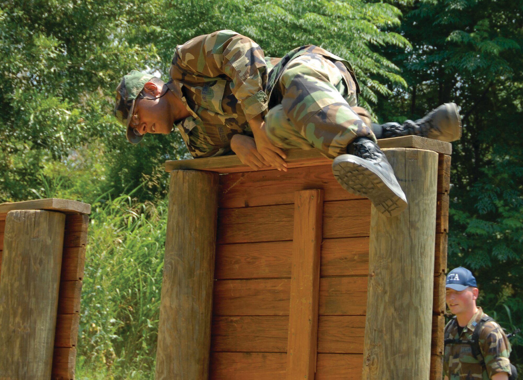 An Air Force ROTC cadet maneuvers over a barrier on the obstacle course at Maxwell's field training site, "Blue Thunder." The cadets are part of the 2009 Field Training for Air Force ROTC cadets from universities around the nation. Field Training is a four-week long program and a requirement towards graduation and ultimately, a commission as a second lieutenant in the Air Force. (U.S. Air Force photo/Jamie Pitcher)