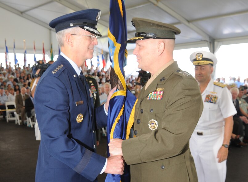 Air Force Gen. Douglas M. Fraser, commander of Southern Command, receives the guidon from Marine Gen. James E. Cartwright, vice chairman of the Joint Chiefs of Staff, during the change of command ceremony at Southern Command headquarters. Fraser relieved Navy Adm. James Stavridis as commander of SOUTHCOM. Stavridis, will head to Stuttgart, Germany, to take over European Command and become the supreme allied commander of Europe. (Photo by J.J. Chiari)