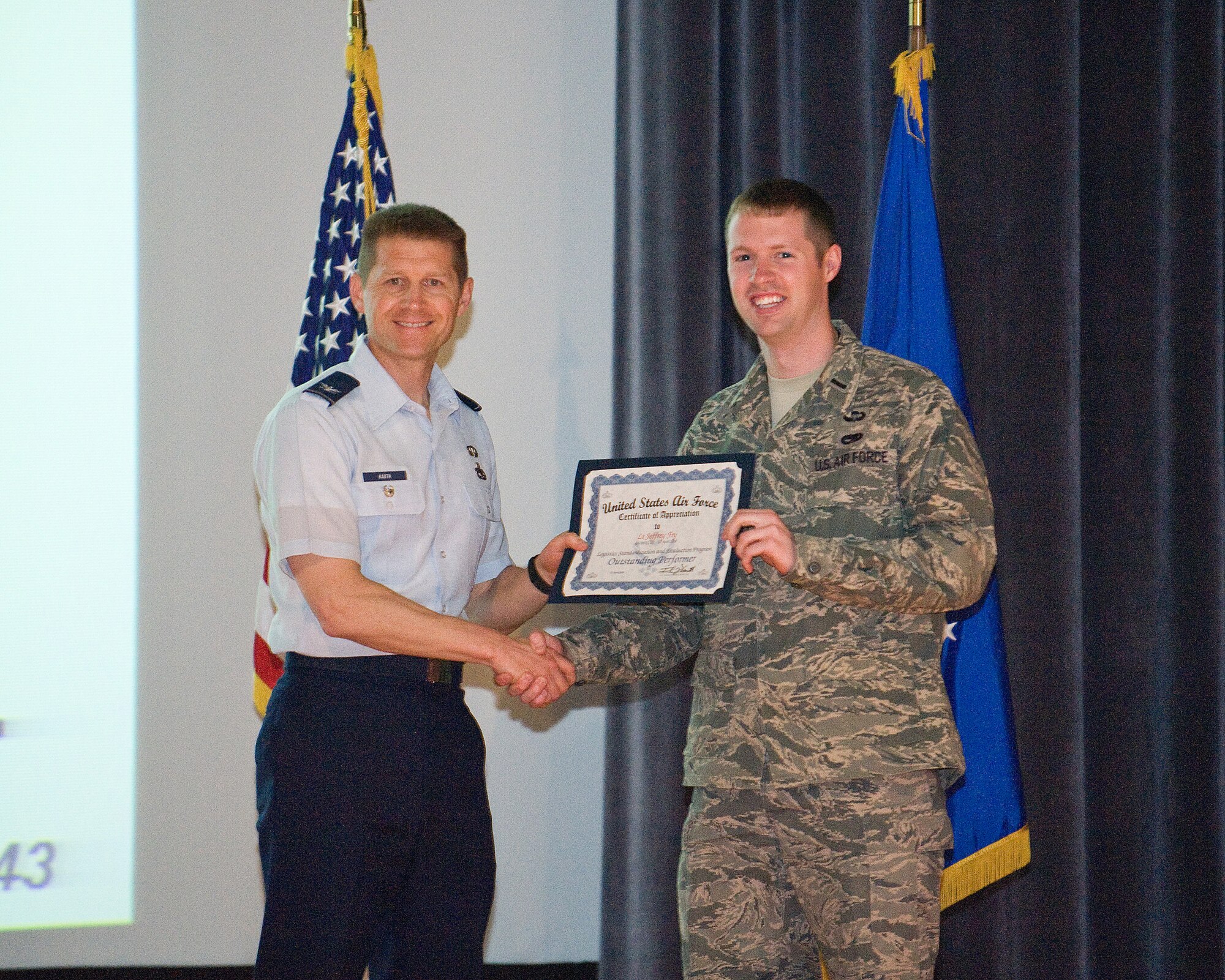 Col. Thomas Kauth, Logistics Assessment Branch chief, presents 1st Lt. Jeff Fry, 436th Maintenance Group executive officer, a certificate of appreciation for his excellence during Dover Air Force Base?s Logistics Standardization and Evaluation Program inspection. Nearly eight months of preparations resulted in the 436th Maintenance and Mission Support Groups earning an overall excellent during the Logistics Standardization and Evaluation Program.  (U.S. Air Force Photo/Tom Randle)