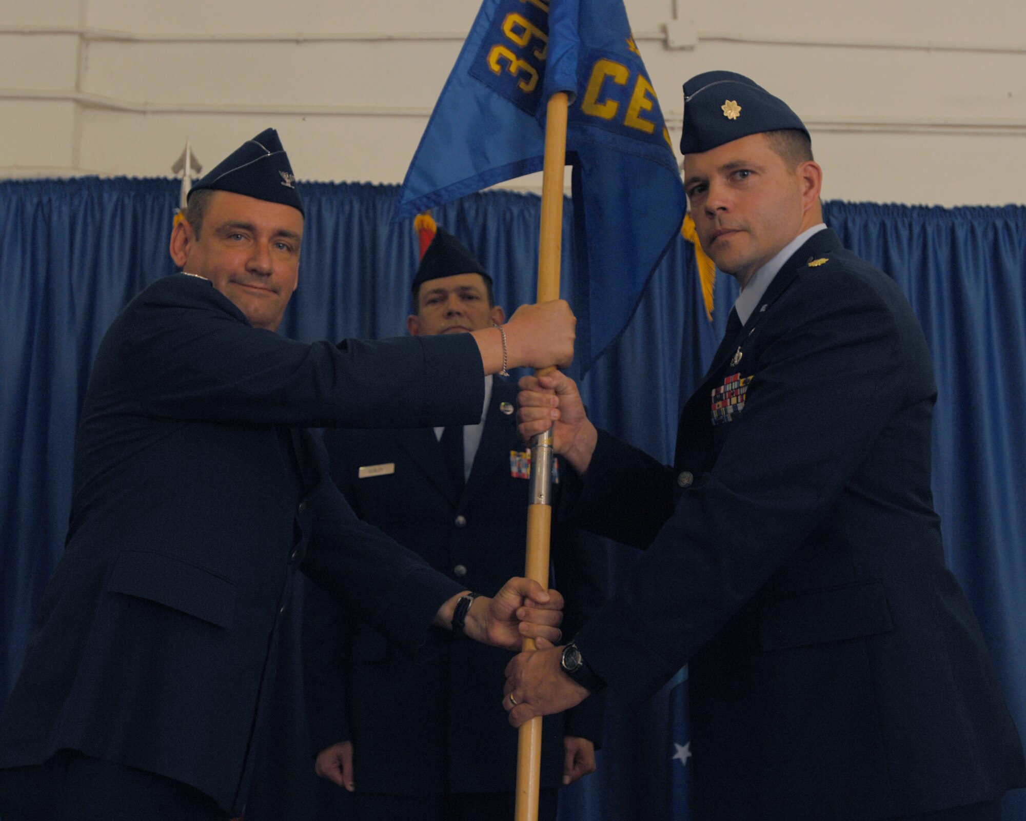 Col. Andrew Pears, the 39th Mission Support Group commander, passes the guidon to incoming commander Maj. Dwayne McCullion, during the Civil Engineer Squadron Change of Command ceremony Thursday, June 25, 2009, Incirlik Air Base, Turkey. The passing of the guidon is a time honored tradition symbolizing the acceptance of command in the Air Force. Major McCullion was a flight commander for the 62nd CES at McChord AFB, Washington, prior to his permanent change of station. (U.S. Air Force photo/Staff Sgt. Lauren Padden)