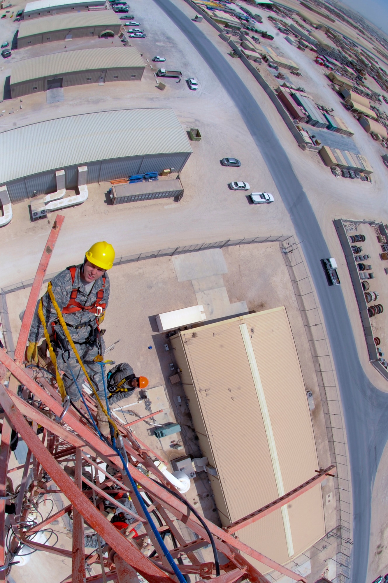 Senior Airman Richard Coyle, and Senior Airman Jawarski Jeffries, both cable and antenna maintenance technicians with the 379th Expeditionary Communications Squadron, perform preventive maintenance for antennas on a 175ft communications tower, June 23, 2009 in an undisclosed location in Southwest Asia. The tower holds multiple antennas and provides support for a variety of amenities and services on base from Armed Forces Network channels to cellular phone reception.  While maintenance is being performed on the tower all power to the antennas is shut down to ensure the safety of the personnel working on it. Airman Coyle is native to Converse, Texas and is deployed from Langley Air Force Base, Va. while Airman Jeffries hails from Dublin, Ga. and is deployed from Lackland Air Force Base, Texas, both in support of Operations Iraqi and Enduring Freedom and Combined Joint Task Force - Horn of Africa.(U.S. Air Force Photo by Staff Sgt. Joshua Garcia/released)