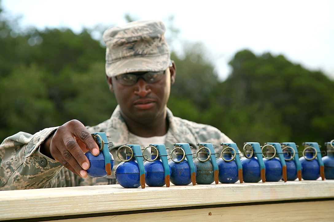 U.S. Air Force Tech. Sgt. Eric Thomas preps M-67 training grenades on Camp Bullis, Texas, June 18, 2009. Thomas is an instructor assigned to the 343rd Training Squadron.