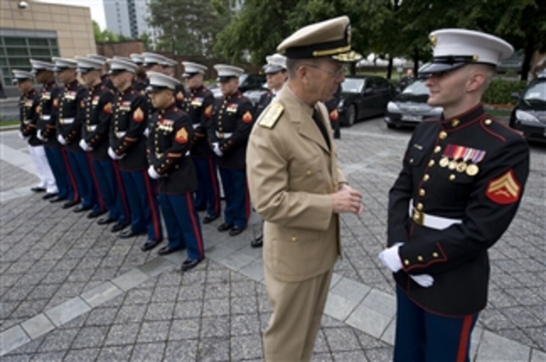 Chairman of the Joint Chiefs of Staff Adm. Mike Mullen, U.S. Navy, speaks with a Marine assigned to the U.S. Embassy in Moscow, Russia, on June 26, 2009.  Mullen is on a three-day trip to the country meeting with counterparts and touring the Russian military academy.  