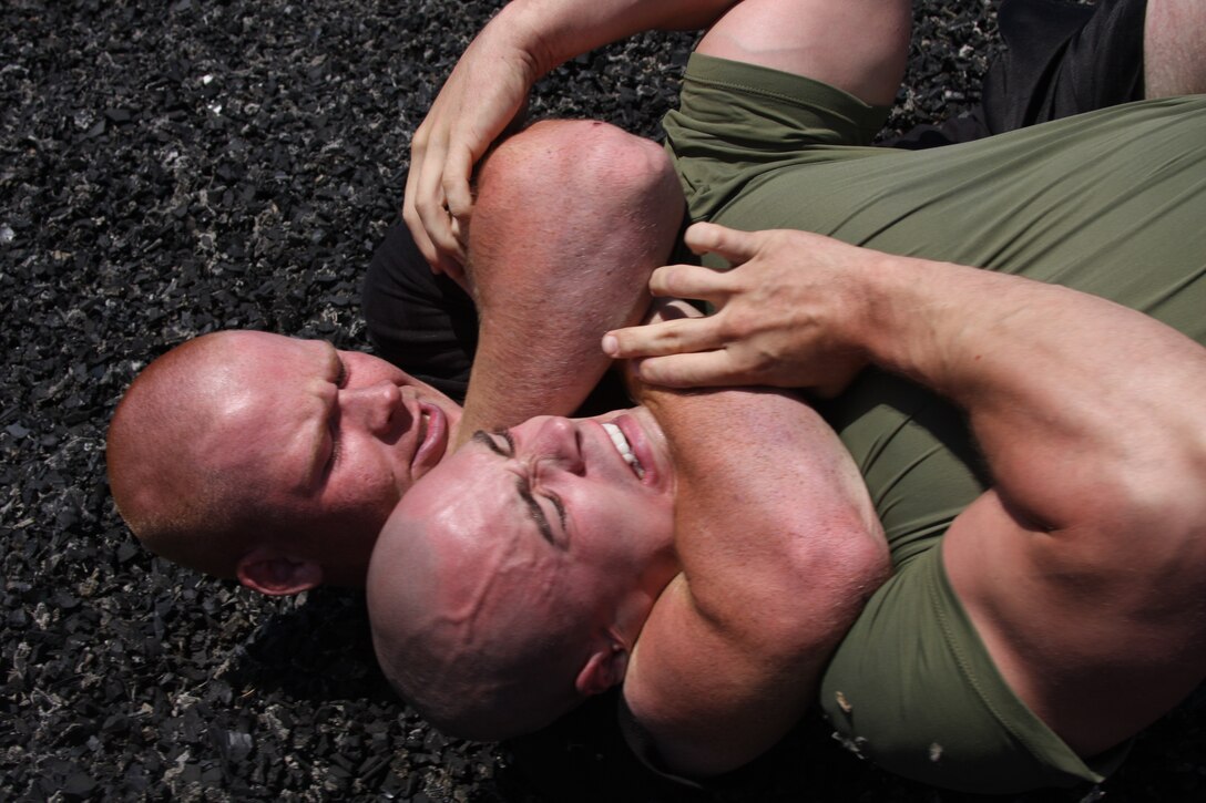 Lance Cpl. Nathan Goens, a heavy equipment operator with Combat Logistics Battalion 7, squeezes the breath out of his former senior drill instructor, Staff Sgt. Nathan Schoemer June 28. After returning to Marine Corps Recruit Depot San Diego to accept Schoemer’s challenge, Goens won the match with this chokehold.