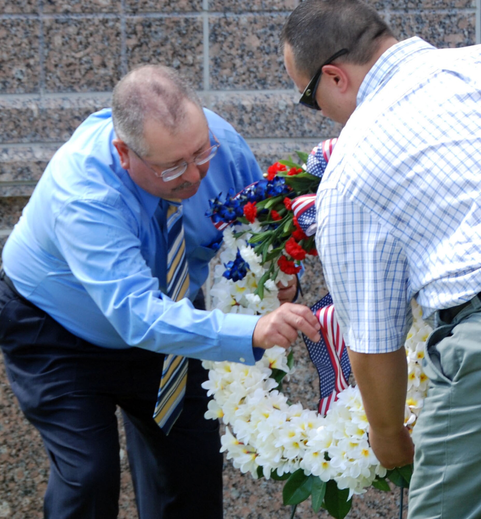 PATRICK AIR FORCE BASE, Fla. - Tech. Sgt. Robert Hudgins (Ret.) and Mr. Darrell Hankins, from 920th Rescue Wing here prepare to lay a wreath during a memorial ceremony June 25 at Memorial Plaza here held to honor five fallen Airmen who were killed in the 1996 Khobar Towers bombing in Saudia Arabia. (U.S. Air Force Photo/Tech Sgt Kristin Mack)