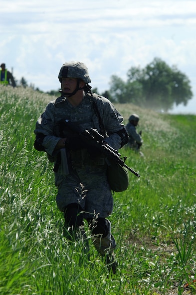 MINOT AIR FORCE BASE, N.D. -- Staff Sgt. Christopher Wilder, 91st Missile Security Forces Squadron member, moves into position during a Nuclear Surety Inspection protest exercise here June 23.  An NSI is designed to evaluate a unit's readiness to execute nuclear operations and takes place at least every 18 months. (U.S. Air Force Photo by Tech Sgt. Lee A. Osberry Jr.)