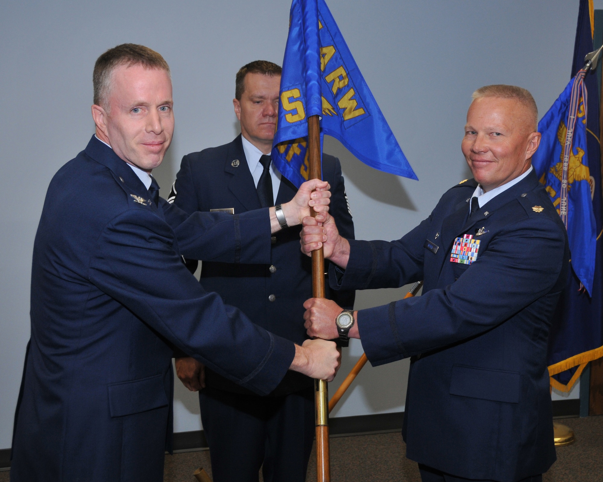 Col Kenneth L Gammon, 151st Mission Support Group commander, transfers the 151st Security Forces guidon to the new commander  Maj. David Todd Meyer during the change of command ceremony June 7 at Utah Air National Guard Base, Salt Lake City, Utah.
U.S.Air Force photo by Tech Sgt Michael D Evans

