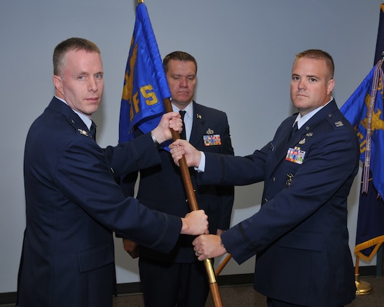 Col Kenneth L Gammon, 151st Mission Support Group commander, receives the 151st Security Forces guidon from Capt. Kevin K. Larsen during the change of command ceremony June 7 at the Utah Air National Guard Base, Salt Lake City, Utah. Captain Larsen is transferring to take command of the Weapons of Mass Destruction Civil Support Team at the armory in Lehi, Utah. 