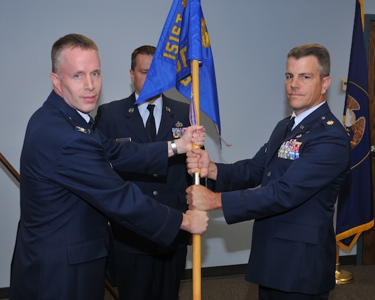 Col Kenneth L Gammon, 151st Mission Support Group commander, Utah Air National Guard, transfers the 151st Military Personnel Flight guidon to the new commander  Maj. Mark W. Roberts during the change of command ceremony June 7 at Utah Air National Guard Base, Salt Lake City, Utah.
U.S.Air Force photo by Tech Sgt Michael D Evans
