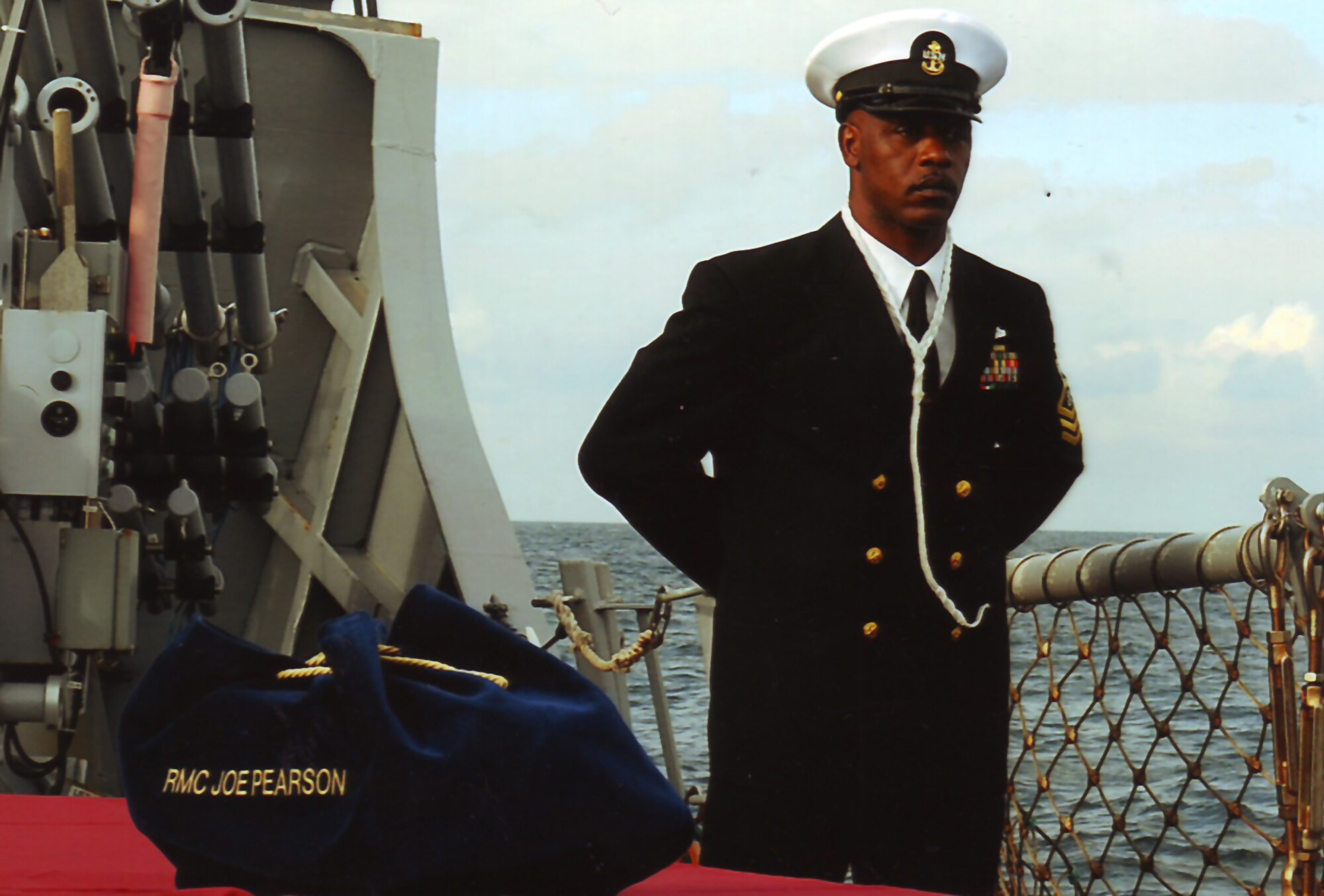 Chief Bosun's Mate of the USS Porter Stands Watch over the urn containing  the ashes of Chief Radioman Joe Pearson before its committal to the deep off the coast of Normandy France.  The service aboard eh USS Porter was carrier out 65 years and one day after RMC Pearson first landed at Utah beach under fire on June 6, 1944 (Photo Courtesy USS Porter)