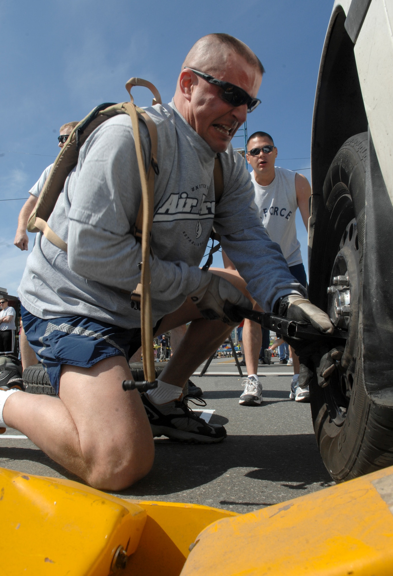 ANCHORAGE, Alaska -- Master Sgt. Chris Schott tightens up the lug nuts on a tire of an Anchorage Police Department cruiser during the 2009 Hero Games June 27. Hero Games brought military and civilian teams together in a friendly competition of various games such as water balloon volleyball, tug o' war and litter carry. Schott is a member of the 3rd Civil Engineer Squadron. (U.S. Air Force photo/Senior Airman David Carbajal)