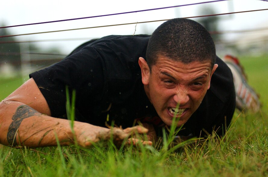 An Army soldier crawls through an obstacle coarse during the Battle of the Services Fitness Challenge 2009 at Kadena Air Base, Japan June 26.
(U.S. Air Force photo/Tech. Sgt. Rey Ramon)            