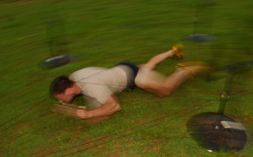 An Army soldier from the 1st Battalion Special Forces crawls through an obstacle course during the Battle of the Services Fitness Challenge 2009 at Kadena Air Base, Japan June 26.
(U.S. Air Force photo/Tech. Sgt. Rey Ramon)               