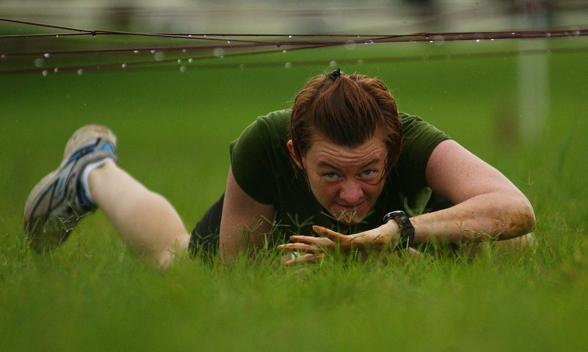 A military member crawls through an obstacle course during the Battle of the Services Fitness Challenge 2009 at Kadena Air Base, Japan June 26.
(U.S. Air Force photo/Tech. Sgt. Rey Ramon)               