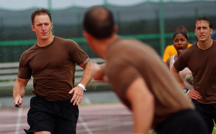 Airmen from the 33d Rescue Squadron compete in a relay run during the Battle of the Services Fitness Challenge 2009 at Kadena Air Base, Japan June 26.
(U.S. Air Force photo/Tech. Sgt. Rey Ramon)         