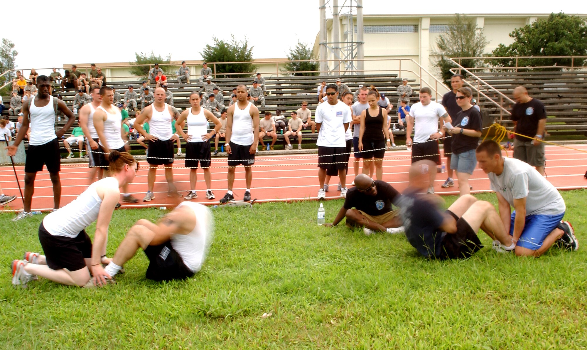 Army soldiers and Airmen root for their own during a sit-up competition in the Battle of the Services Fitness Challenge 2009 at Kadena Air Base, Japan June 26.
(U.S. Air Force photo/Tech. Sgt. Rey Ramon)    