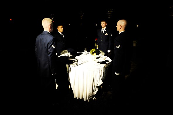 MISAWA AIR BASE, Japan -- Members of the Airman Leadership School Class 09-E take part in a POW/MIA ceremony before graduating June 25, 2009. The vacant table serves as a symbolic remembrance for prisoners of war and those missing in action.  (U.S. Air Force photo/Senior Airman Jamal D. Sutter)