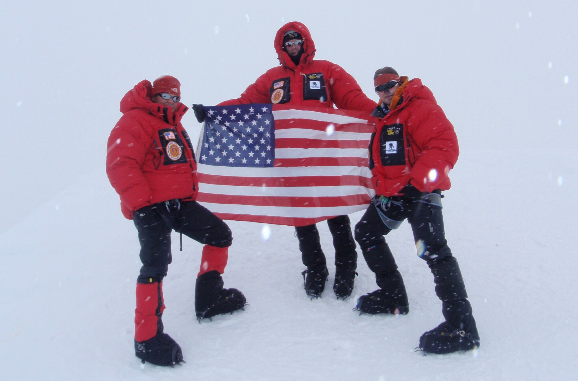 MOUNT MCKINLEY, Alaska -- Army Spc. Dave Shebib, Army Lt. Col. Marc Hoffmeister and climbing mentor Bob Haines hold the American flag at the summit of Mount McKinley June 16. Army Spc. Dave Shebib stands on Mount McKinley June 9. Mount McKinley is the highest peak in North America standing at more than 20,300 feet. (Courtesy photo)