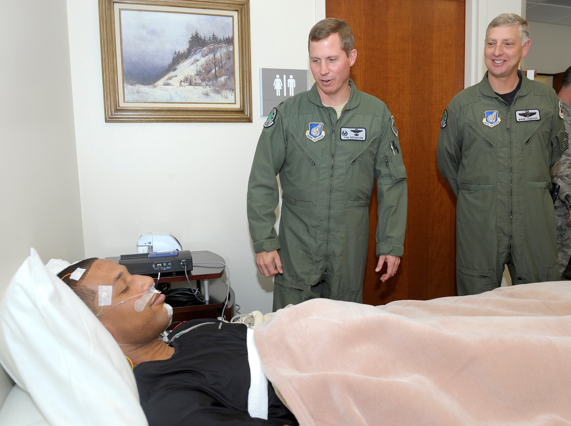ELMENDORF AIR FORCE BASE, Alaska -- Col. Thomas Bergeson and Col. Mark Camerer check out Senior Airman Curtis Singleton, posing as a mock patient, during the grand opening of the Elmendorf Sleep Clinic June 26. This clinic will have the ability to record brain activity, eye movement, oxygen and carbon dioxide blood levels, heart rate and rhythm, breathing rate and rhythm, snoring, leg movement, and chest and belly movement to help patients with sleep disorders. Bergeson is the 3rd Wing commander and Camerer is the 3rd Wing vice commander. (U.S. Air Force photo/Master Sgt. Keith Brown)