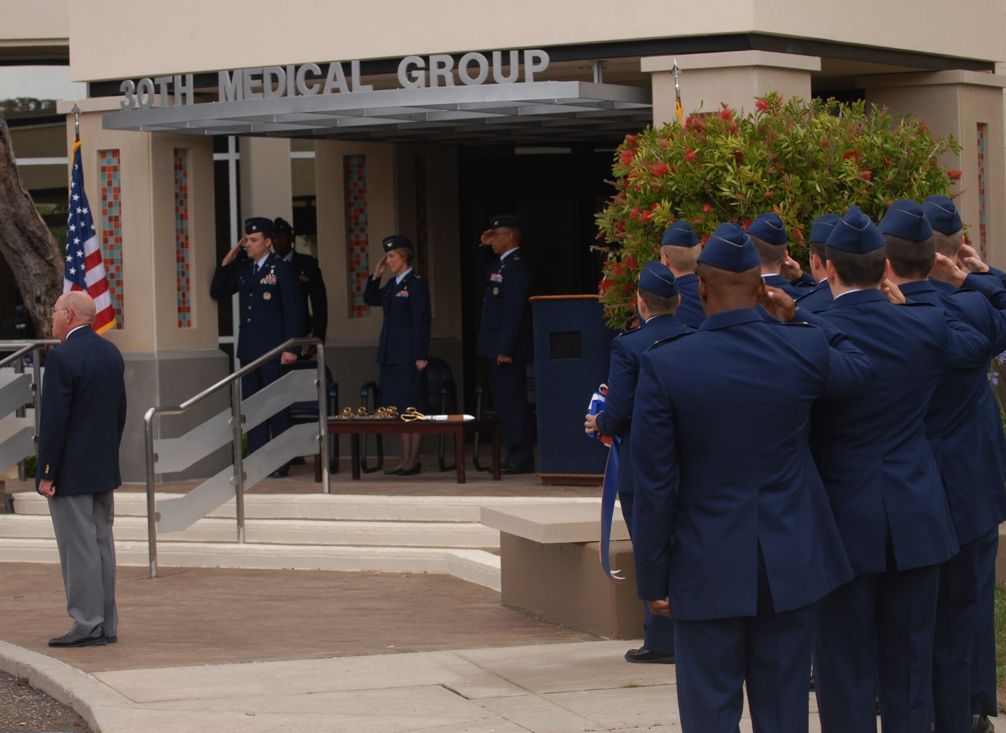 VANDENBERG AIR FORCE BASE, Calif.  -- Team Vandenberg salutes in honor of the National Anthem at a ribbon cutting ceremony held for the grand opening of a new addition to the base’s medical center here June 29. The 30th MDG celebrated the opening of their new clinic here June 29 after all renovations had been completed.  (U. S. Air Force photo/Senior Airman Antoinette Lyons)
