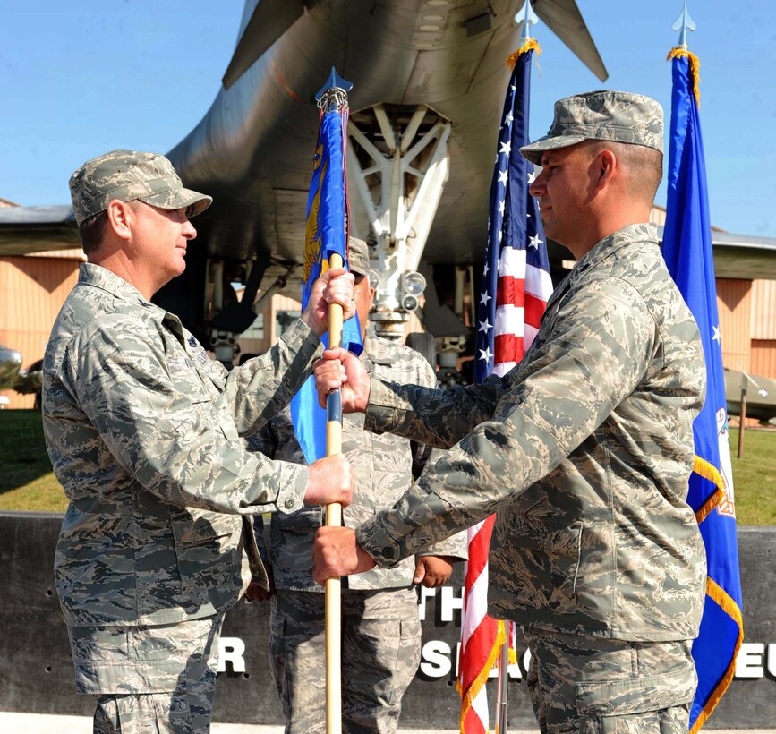 Lt. Col. Matthew Joganich, incoming 28th Civil Engineer Squadron commander, receives the guidon from Col. Michael Yuill, 28th Mission Support Group commander, during the change of command ceremony here, June 29.  Colonel Joganich was the former deputy commander of the 820th Expeditionary “Red Horse” Squadron, Nellis Air Force Base. (U.S. Air Force photo by Airman 1st Class Adam Grant) 

