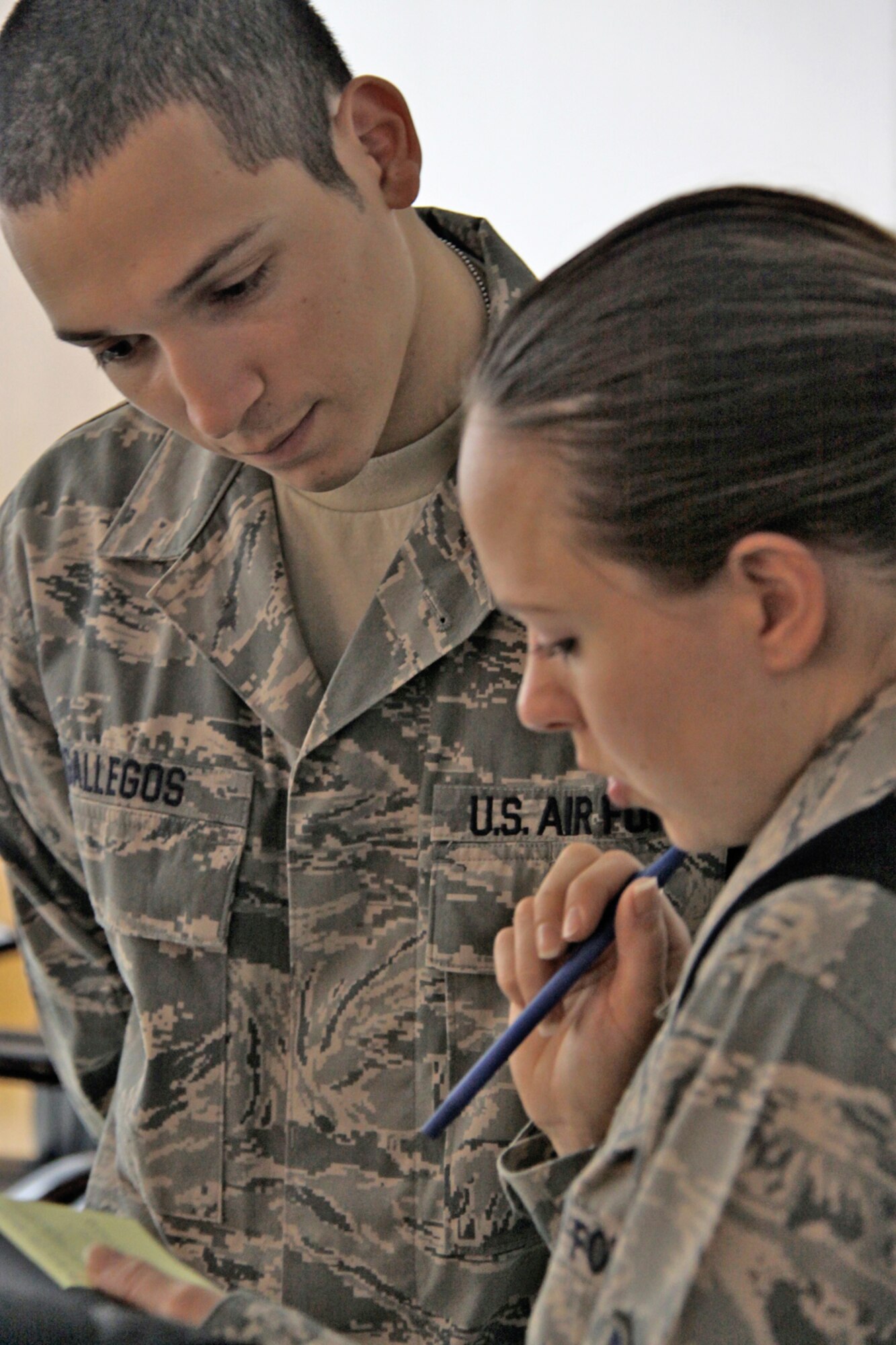 Staff Sgt. Juan Gallegos answers a question from Staff Sgt. Cheri Longenecker during the unit information management officer course recently at Camp Taji, Iraq. Sergeant Gallegos and his team teach this course weekly to train servicemembers to be a direct point of contact to help resolve computer system issues within their individual units. Sergeant Gallegos is a 518th Tactical Installation and Networking system administrator deployed from Hill Air Force Base, Utah. He is a native of Robert Lee, Texas. Sergeant Longenecker is the Counterinsurgency Center for Excellence command, control, communications, and computer systems staff section NCO in charge deployed from Ramstein Air Base, Germany. She is a native of Lancaster, Penn. (U.S. Air Force photo/Tech. Sgt. Lionel Castellano) 
