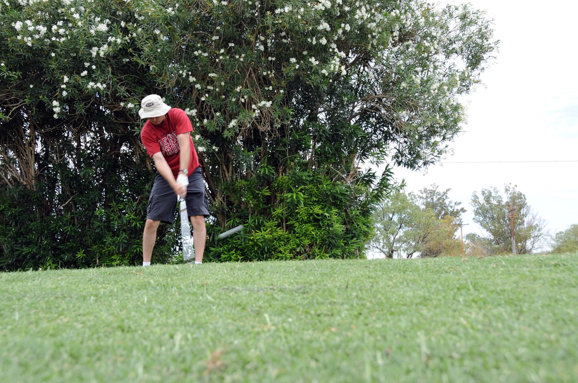Master Sgt. Garrett Smith, 355th Security Forces Squadron, watches as he hits a golf ball during a golf tournament here June 26. The golf tournament was a fund raiser help to support this years Senior Non-Commisioned Officer Induction Ceremony. (U.S. Air Force photo/Master Sgt. Heather Cabral)