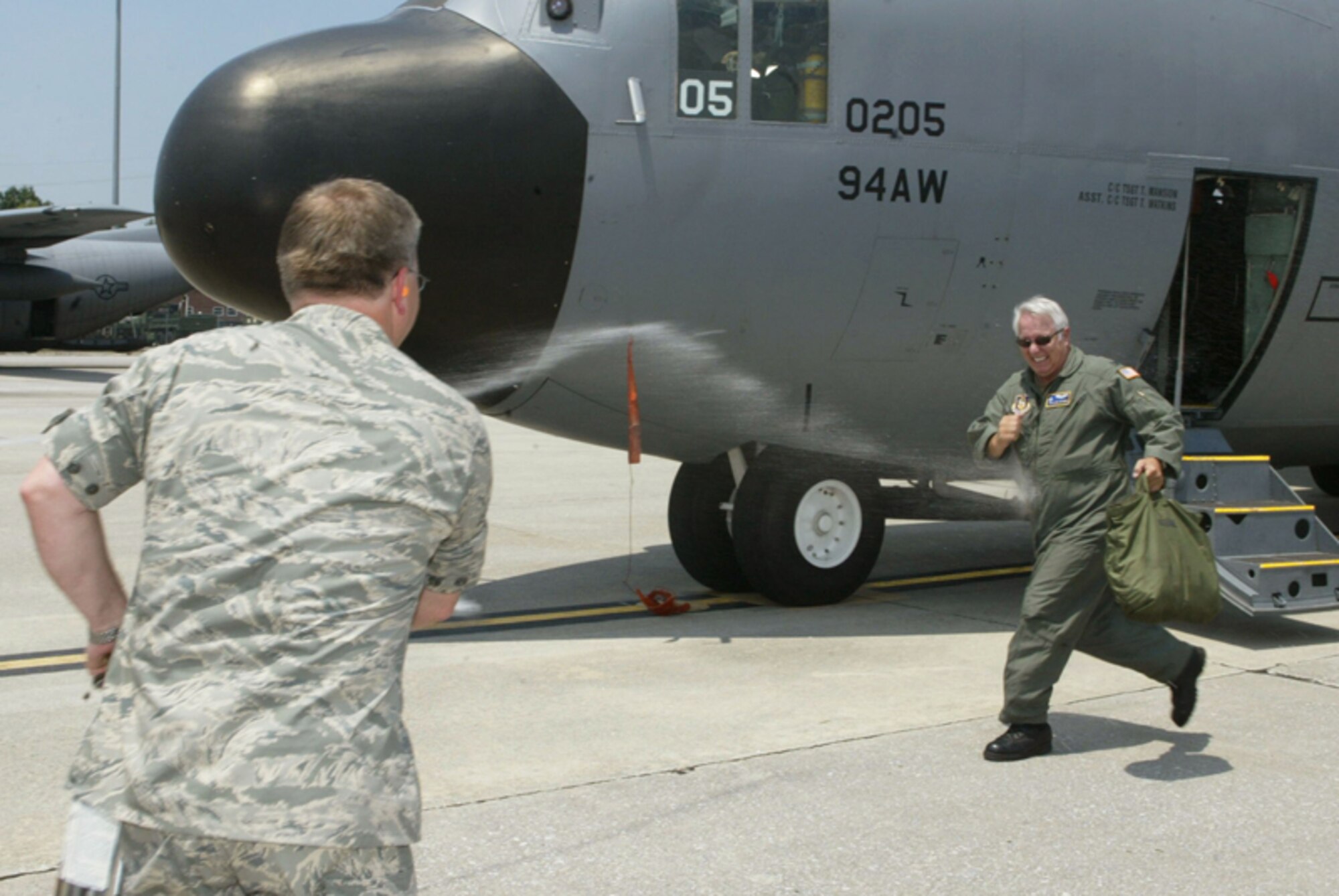 Chaplain (Col.) James A. Withers from the 22nd Air Force receives the traditional fini-flight hose down from his staff and other members of the 22AF after taking the final flight of his Air Force career on Dobbins Air Reserve Base on Jun. 25.