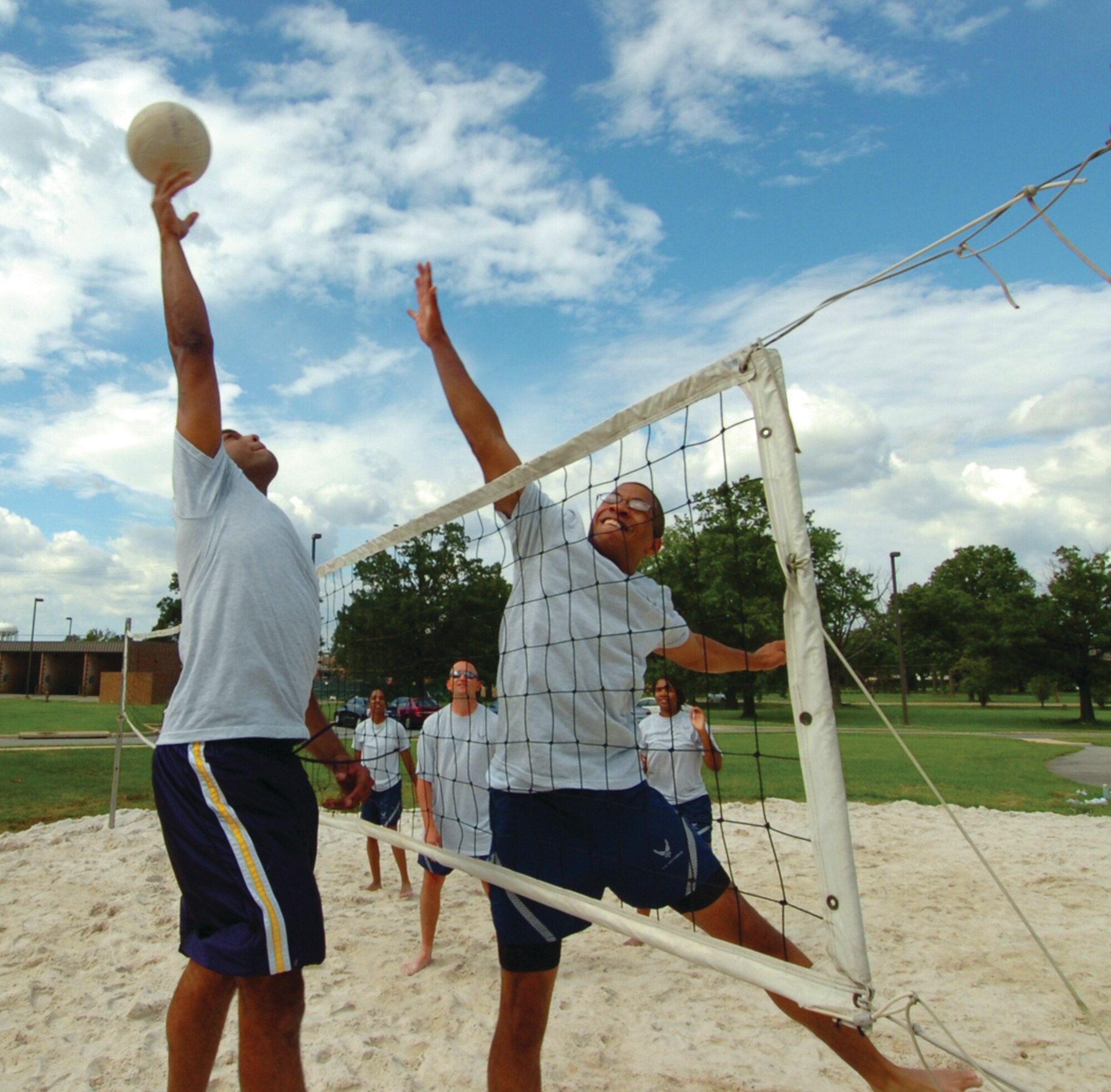 Christian Donovan, left, spikes a volleyball against Rashad Norri, right, during a 316th Contracting Squadron game of volleyball near their dormitories Monday. The members enjoyed their games on freshly poured sand delivered by the 316th Civil Engineer Squadron and filled in by the 316th Security Forces Squadron. (U.S. Air Force photo/ Bobby Jones)