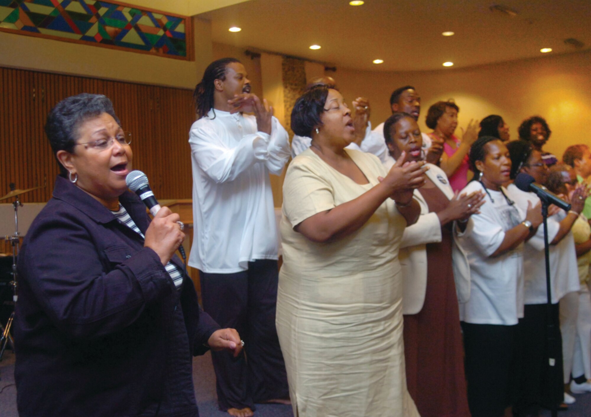 Joyce Moore, Bolling Air Force Base gospel choir director, leads the Bolling Gospel Choir in song during a program observing 140th Juneteenth anniversary at Chapel III June 19. During the celebration, Andrews members were treated to food, refreshments and entertainment for the children, who played on a moon bounce in front of the chapel. Juneteenth is the oldest known celebration commemorating the ending of slavery in the United States. On June 19, 1865, Union Soldiers, led by Maj. Gen. Gordon Granger, landed at Galveston, Texas with news that the war had ended and the enslaved were now free. The Soldiers arrived two and a half years after President Lincoln’s Emancipation Proclamation, which became official January 1, 1863. (U.S. Air Force photo/ Bobby Jones)