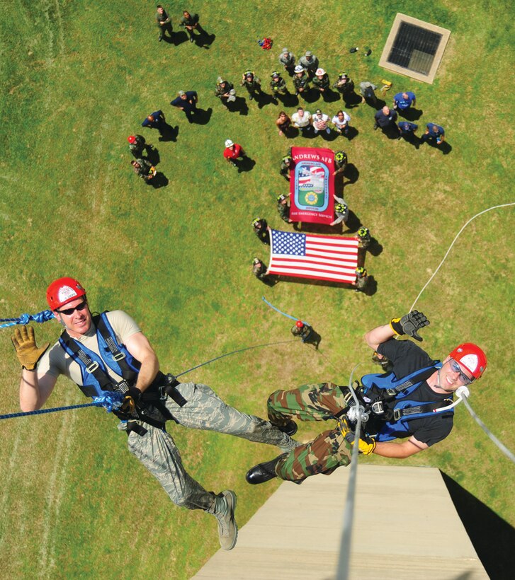 Colonel Steven M. Shepro, 316th Wing/Andrews AFB commander, gives the Oath of Enlistment to Senior Airman Bryan Hoover, 316th Civil Engineering Squadron firefighter, from a 150 foot rappel off of the Andrews Air Traffic Control Tower on Wednesday. Airman Hoover was joined by family and fellow firefighters, who afterwards enjoyed a tour of “Air Force Two.” (U.S. Air Force photo/ Senior Airman Steven R. Doty)