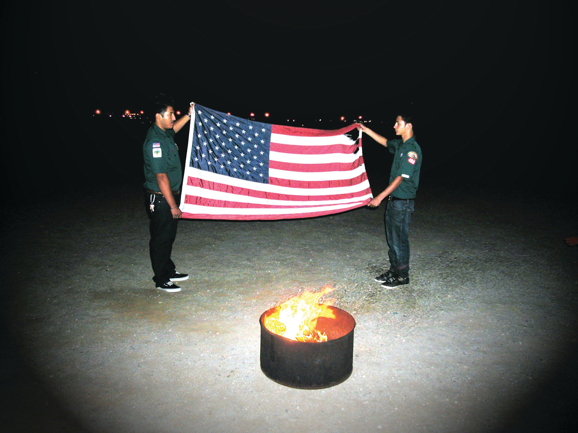 Two scouts from the Boy Scouts of America, Venturer Crew 488, retire a flag during the eighth Rally ‘Round the Flag dinner at the March Field Air Museum. The event is sponsored by the Moreno Valley Chamber of Commerce Military Affairs Committee. Col. Jeff Robertson, Fourth Air Force director of staff and the master of ceremonies,  provided flag trivia during the event. Guest speaker Brig. Gen. James Melin, 452 AMW commander, explained the significance of honoring the flag. The March ARB Total Force Color Guard opened the ceremony with the presentation of the colors and the Moreno Valley Master Chorale supplied the entertainment with patriotic melodies. (U.S. Air Force photo by Maj. Don Traud)