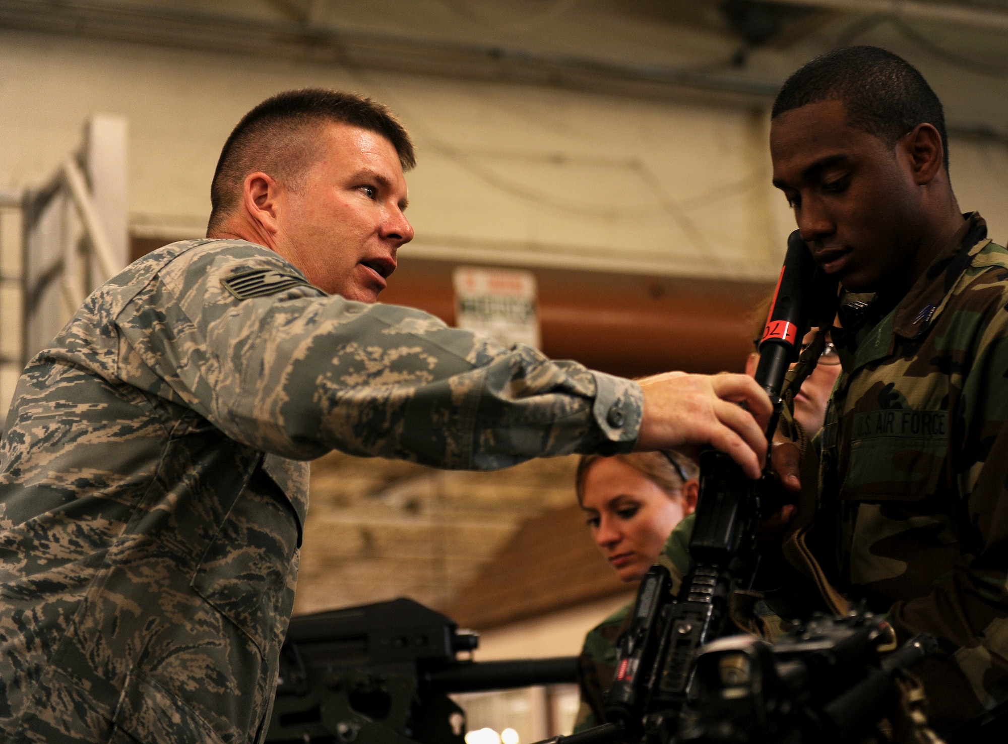 MOODY AIR FORCE BASE, Ga. -- Tech. Sgt. Vernon Bird, 820th Combat Operations Squadron combat arms trainer, shows Cadet Deanglo Mitchell from the U.S. Air Force Academy, how to operate the weapon here June 24. (U.S. Air Force photo by Airman 1st Class Joshua Green)