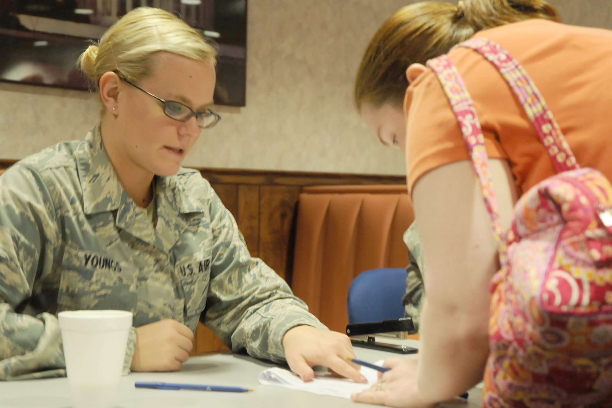 YOUNGSTOWN AIR RESERVE STATION, Ohio -- Airman 1st Class Caitlyn M. Youngs, a personnel specialist assigned to the 910th Mission Support Flight here, gives instructions to an Inactive Ready Reservist (IRR) during an IRR screening here June 13, 2009.  These prior servicemembers are called upon periodically to update information to determine who would be activated for duty if needed and to provide them with recruiting opportunities. (U.S. Air Force photo by Tech. Sgt. Dennis Kilker)