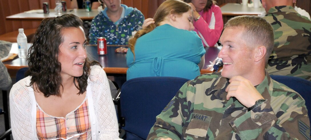 YOUNGSTOWN AIR RESERVE STATION, Ohio -- Staff Sgt. Travis Newhart, a fire protection specialist assigned to the 910th Civil Engineers Squadron here, shares information with his girlfriend, Kathryn Kane, during a Yellow Ribbon Reintegration event at the dining facility here June 20, 2009.  During a Yellow Ribbon event servicemembers and their families attend briefings from organizations including  Airmen and Family Readiness, Military One Source, Finance Management and Veterans Affairs.  They particpate in team building exercises that focus on reintegration of the deployed servicemembers.  (U.S. Air Force photo by Megan Tomkins)   