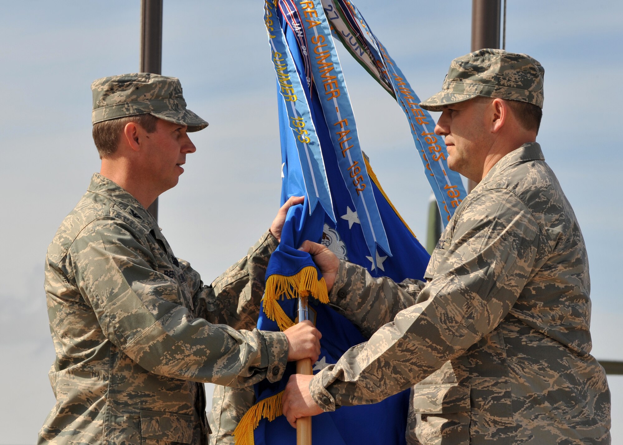 ELMENDORF AIR FORCE BASE, Alaska -- Col. Thomas Bergeson passes the 3rd Maintenance Group flag into the hands of their new commander, Col. Jerry Johnson, during the 3rd MXG change of command June 25. Bergeson is the 3rd Wing commander. (U.S. Air Force photo/Senior Airman Laura Turner)