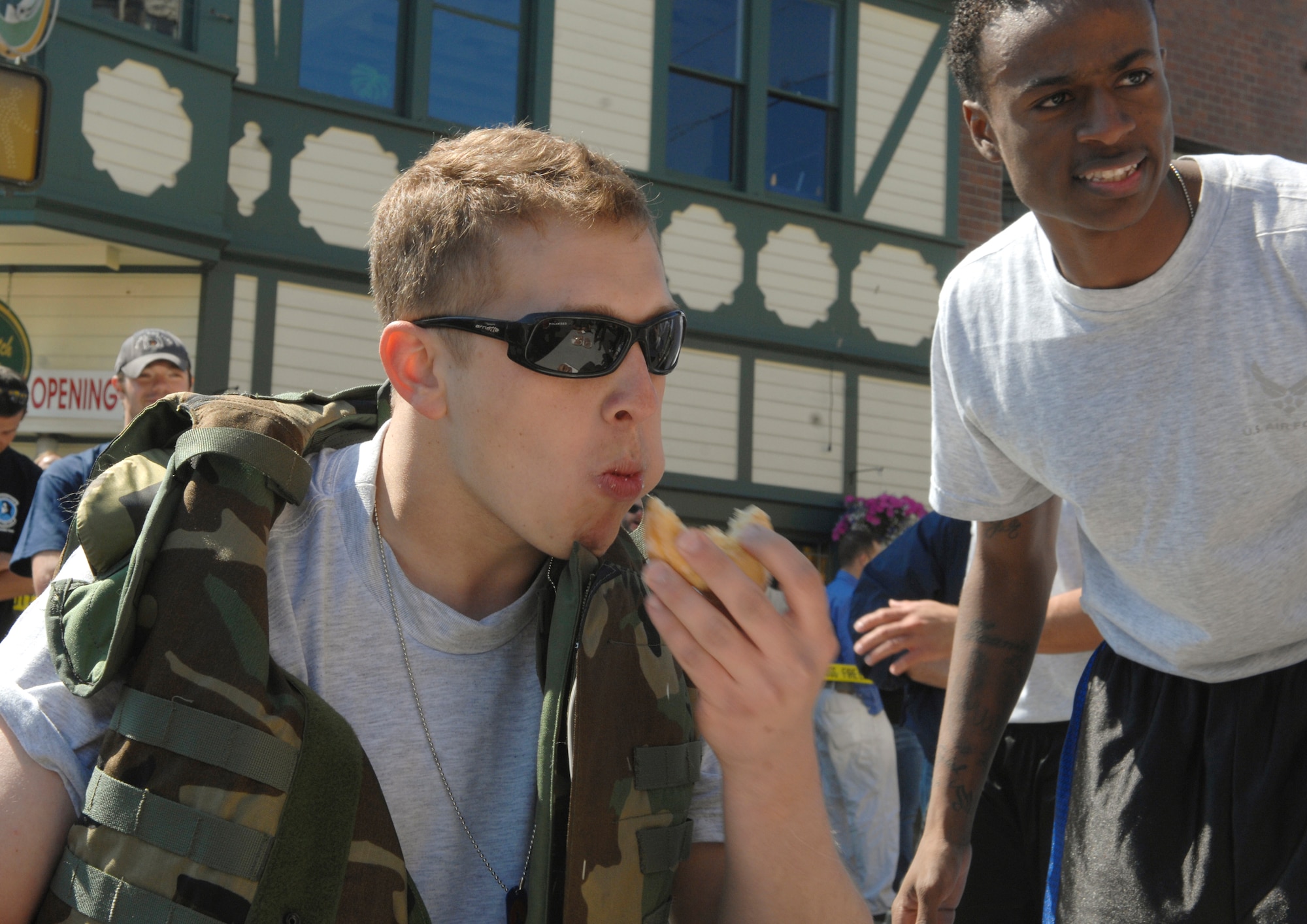 ANCHORAGE, Alaska -- Senior Airman Ryan Blanton chews a donut during the 2009 Hero Games June 27. The donut eating segment was a part of the obstacle course which included fire hose drag, Keiser sled, ladder rescue, tire change and a low crawl. Hero Games brought military and civilian teams together in a friendly competition of various games such as water-balloon volleyball, tug o' war and litter carry. Blanton is a member of the 703rd Aircraft Maintenance Squadron. (U.S. Air Force photo/Senior Airman David Carbajal)