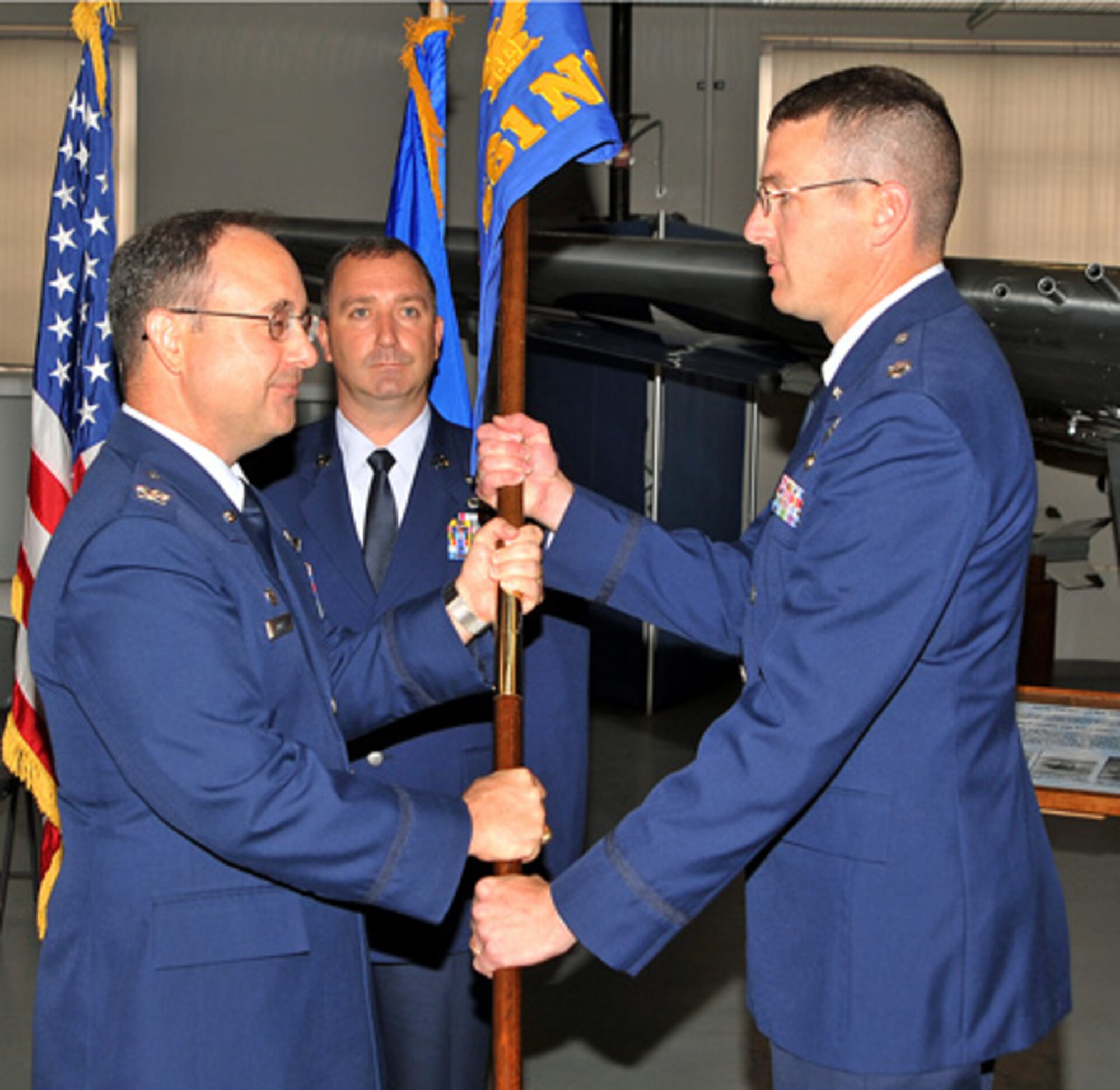 PETERSON AIR FORCE BASE, Colo.--Lt. Col. A. Kevin Yates (right) assumes command of the 561st Network Operations Squadron in a ceremony June 23 at the Peterson Museum Hangar. Col. Donald Locke Jr. (left), 690th Network Support Group commander, passes the squadron’s guidon to Colonel Yates. Prior to his assignment as 561st NOS commander, Colonel Yates served as U.S. Strategic Command Chief of Information Technology, U.S. Strategic Command, Neb. (Air Force photo by 2nd Lt. Jonathan Wong)