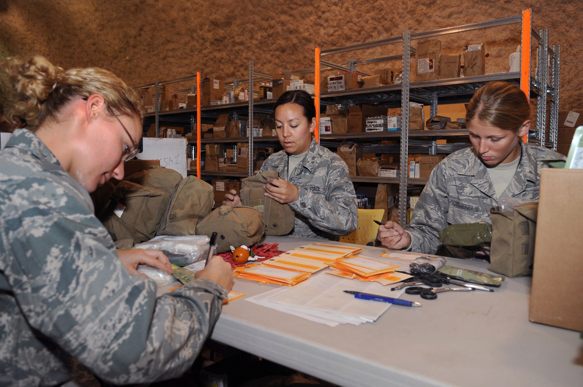 Air Force Academy Cadets, Mallory Morgan (left) Carrie Moore, and Gina Koenigsberger, go over the contents of an Individual First Aid Kit, during the cadet's visit of unit medical facilities, June 25, 2009, in an undisclosed location in Southwest Asia.  The cadets built the IFAKs as part of their tour of the 379th Expeditionary Medical Group. Cadet Morgan hails from Parker, Texas, Cadet Moore is originally from Tucson Ariz. and Cadet Koenigsbeger is native to Milwaukee, Wis., all are visiting from the Air Force Academy, Colo. to learn and gain experience about Operations Iraqi and Enduring Freedom and Combined Joint Task Force - Horn of Africa.  (U.S. Air Force Photo by Staff Sgt. Joshua Garcia/released)