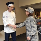 Chief Master Sgt. Cari Kent, 341st Missile Wing command chief, shakes the hand of Staff Sgt. Jeffrey Kaplan, 341st Force Support Squadron dining facility shift leader, May 27. The Chief spent her first two weeks getting out and meeting the enlisted force that supports the mission at Malmstrom.(U.S. Air Force photo/John Turner)