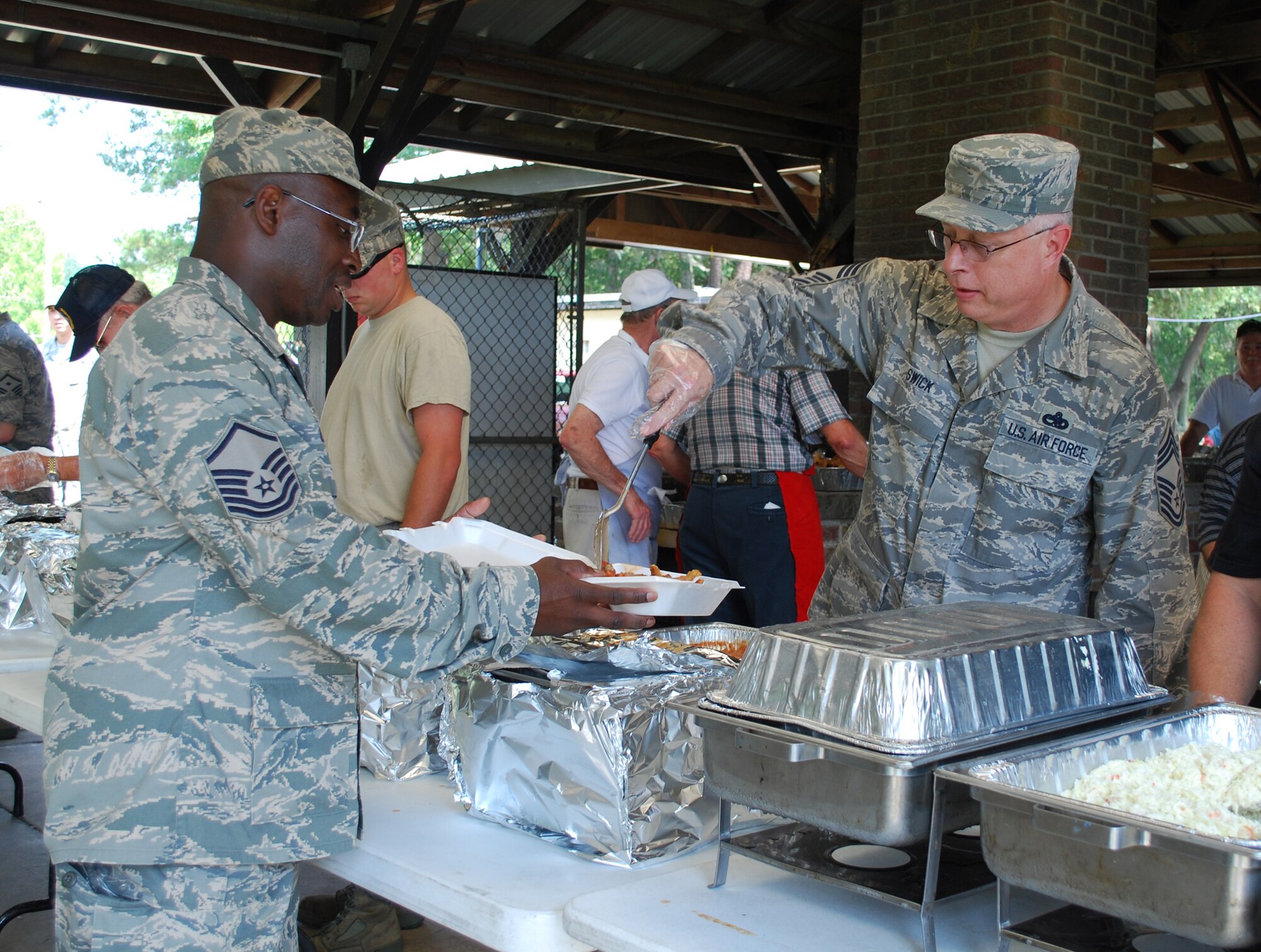 Chief Master Sergeant Timothy Swick, a reservist with the 315th Aircraft Maintenance Squadron at Charleston Air Force Base, S.C., serves Master Sergeant Thomas Ocean from the 81st Aerial Port Squadron during the 315th Alumni Association fish fry to welcome the Wing’s new commander, Colonel Steven Chapman.  Colonel Chapman joined the Wing in April and enjoyed the welcome from the Wing’s Alumni Association.
