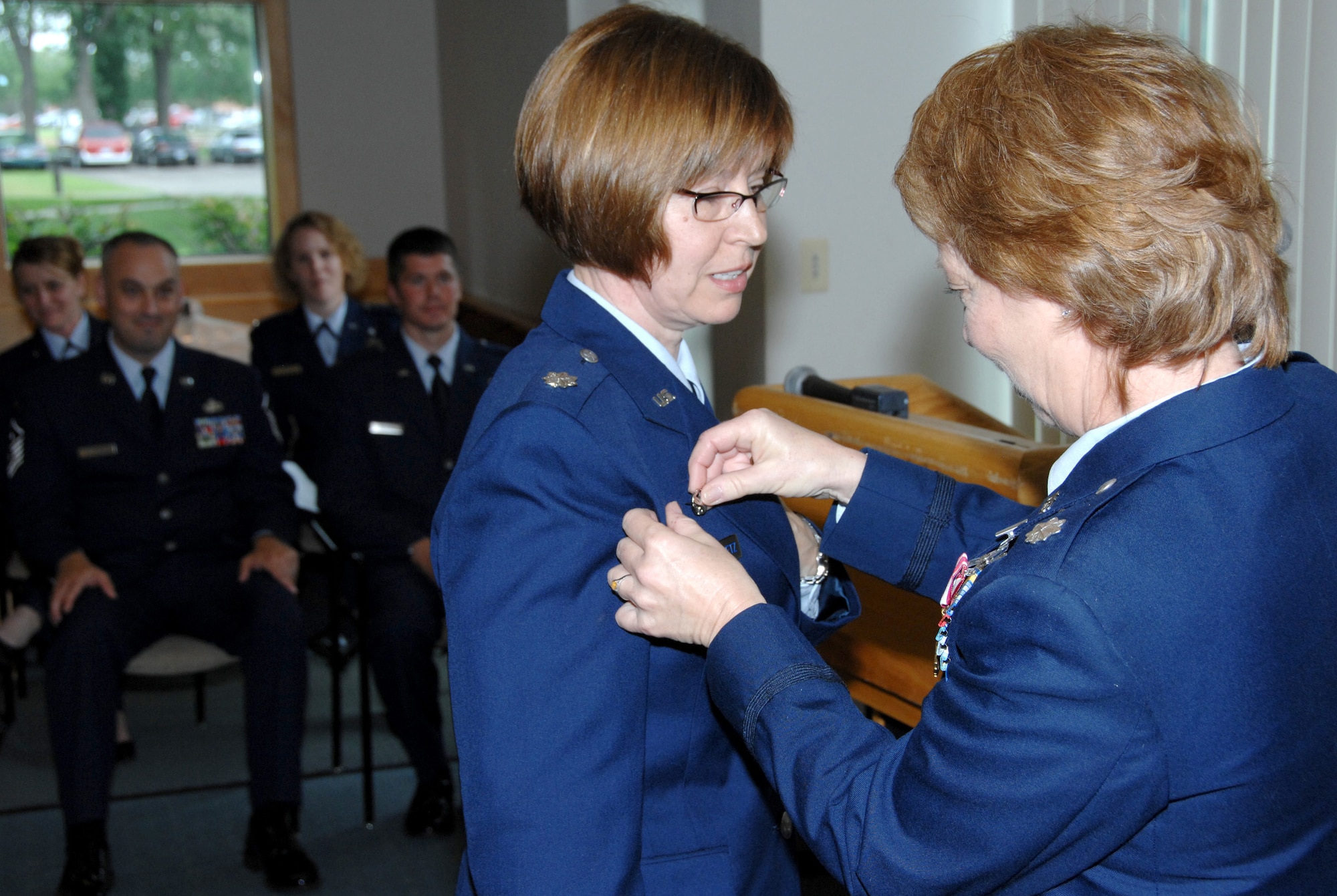 Lt. Col. Georgeanne Johnson (right) pins her Air Force Commander?s Badge on Lt. Col. Penny Hodges-Goetz?s uniform after passing on the command of the 109th Aeromedical Evacuation. The change of command ceremony was on June 21, 2009 at the 133rd Airlift Wing?s dining hall on the airbase in St. Paul, Minn. Lt Col Hodges-Goetz takes command of the 109the AES after serving as the chief nurse for the 133rd Medical Squadron and has been in the military since 1990. Lt. Col. Johnson assumes her new position as the Deputy Commander of the 133rd Operations Group, 133rd Airlift Wing, Minnesota Air National Guard. Air Force Commander's Insignia is a badge of the United States Air Force which has been in existence since 2002. The pin is also known as the USAF Commander?s Badge. The Change of Command ceremony is a time-honored tradition which formally symbolizes the continuity of authority as the command is passed from one individual to another.  It is a formal ceremony which is conducted before the assembled company of the Command. USAF photo by Tech. Sgt. Erik Gudmundson
  