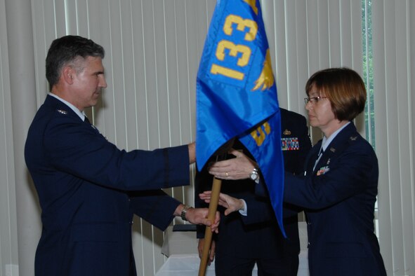 Lt. Col. Penny Hodges-Goetz (right) receives the flag of command for the 109th Aeromedical Evacuation Squadron, Minnesota Air National Guard from Col. Greg Haase, Commander 133rd Airlift Wing, Minnesota Air National Guard during a change of command on Sunday, June 21, 2009 at the 133rd Airlift Wing dining hall on the air base in St. Paul, Minn. The ceremony is a time-honored tradition which formally symbolizes the continuity of authority as the command is passed from one individual to another, conducted before the assembled company of the command.  Lt. Col. Georgeanne Johnson, the former commander of the 109th AES, assumes her new position as the Deputy Commander of the 133rd Operations Group, 133rd Airlift Wing. USAF photo by Tech. Sgt. Erik Gudmundson