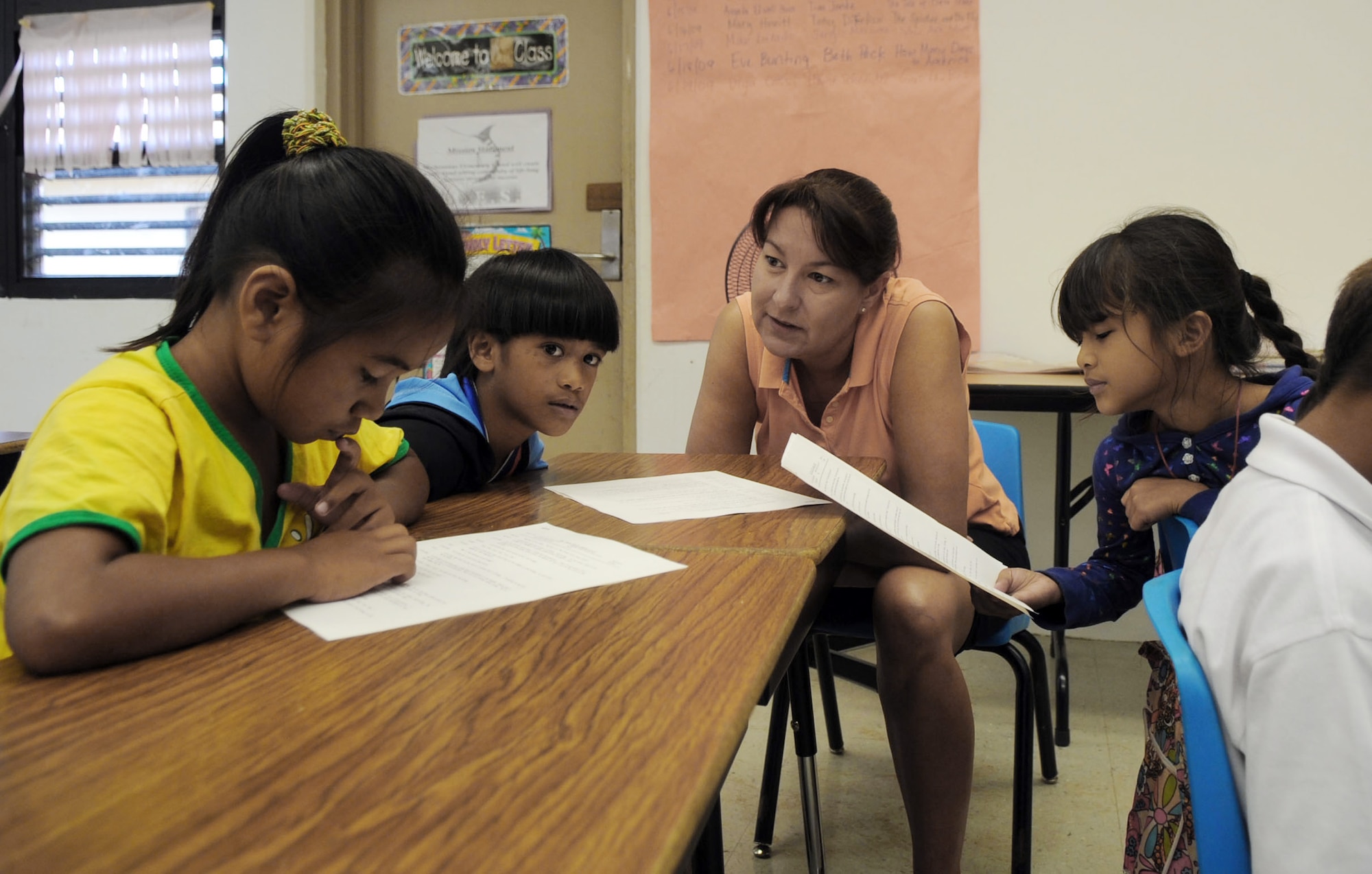 Master Sgt. Lisa Robinson reads to second graders June 19 at Machananao Elementary School in Agana, Guam. The Bozeman, Mont., native is deployed to Andersen Air Force Base, Guam, from Elmendorf AFB, Alaska, to support U.S. Pacific Command's continuous bomber presence in the Asia-Pacific Region. Sergeant Robinson is a first sergeant with the 525th Expeditionary Fighter Squadron. (U.S. Air Force photo/Senior Airman Christopher Bush) 
