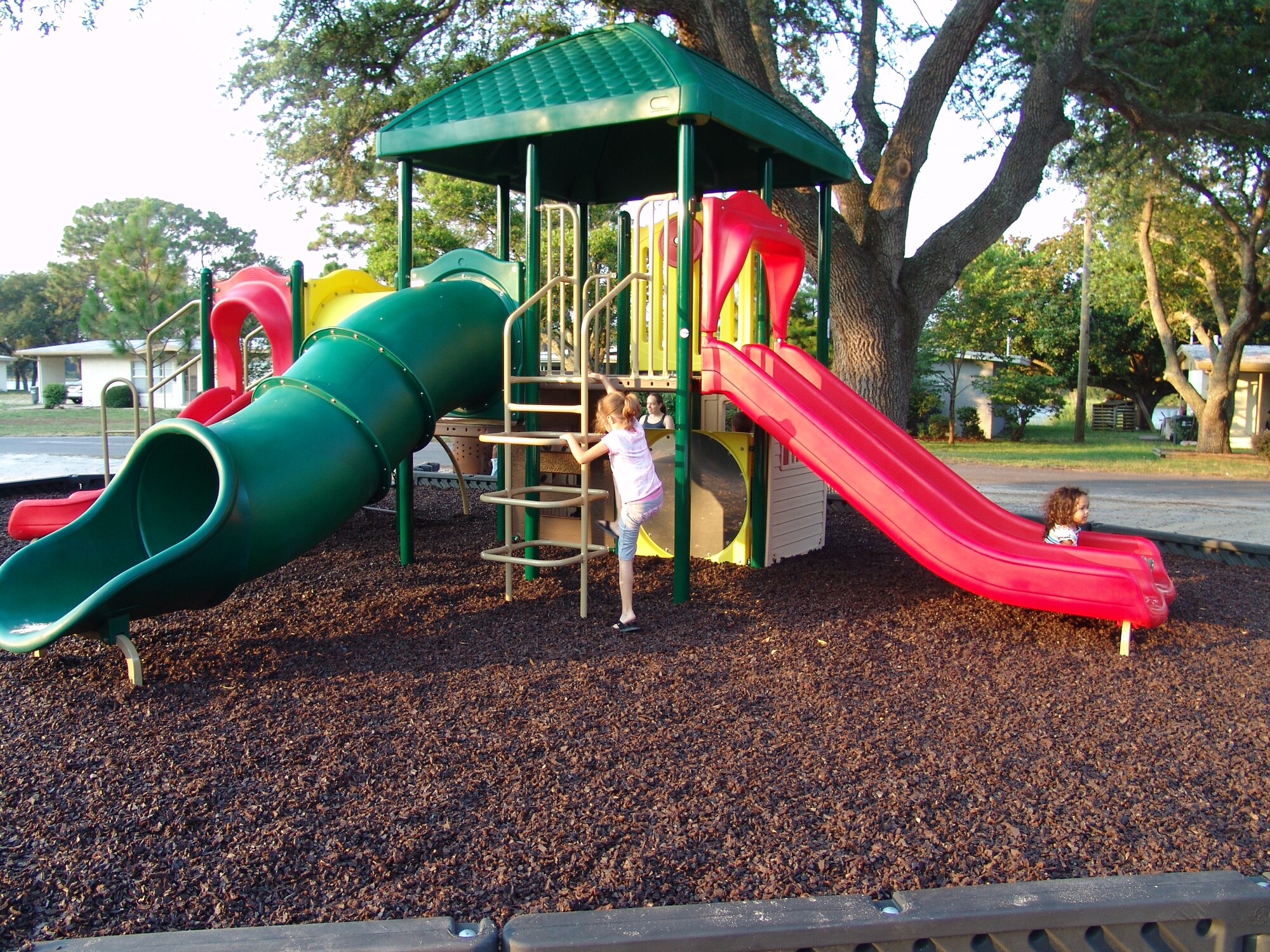 Children enjoy playing on the new equipment on Chinquapin Drive.  Three new playgrounds are now open for children living in base housing. (USAF photo/Lois Walsh)                        