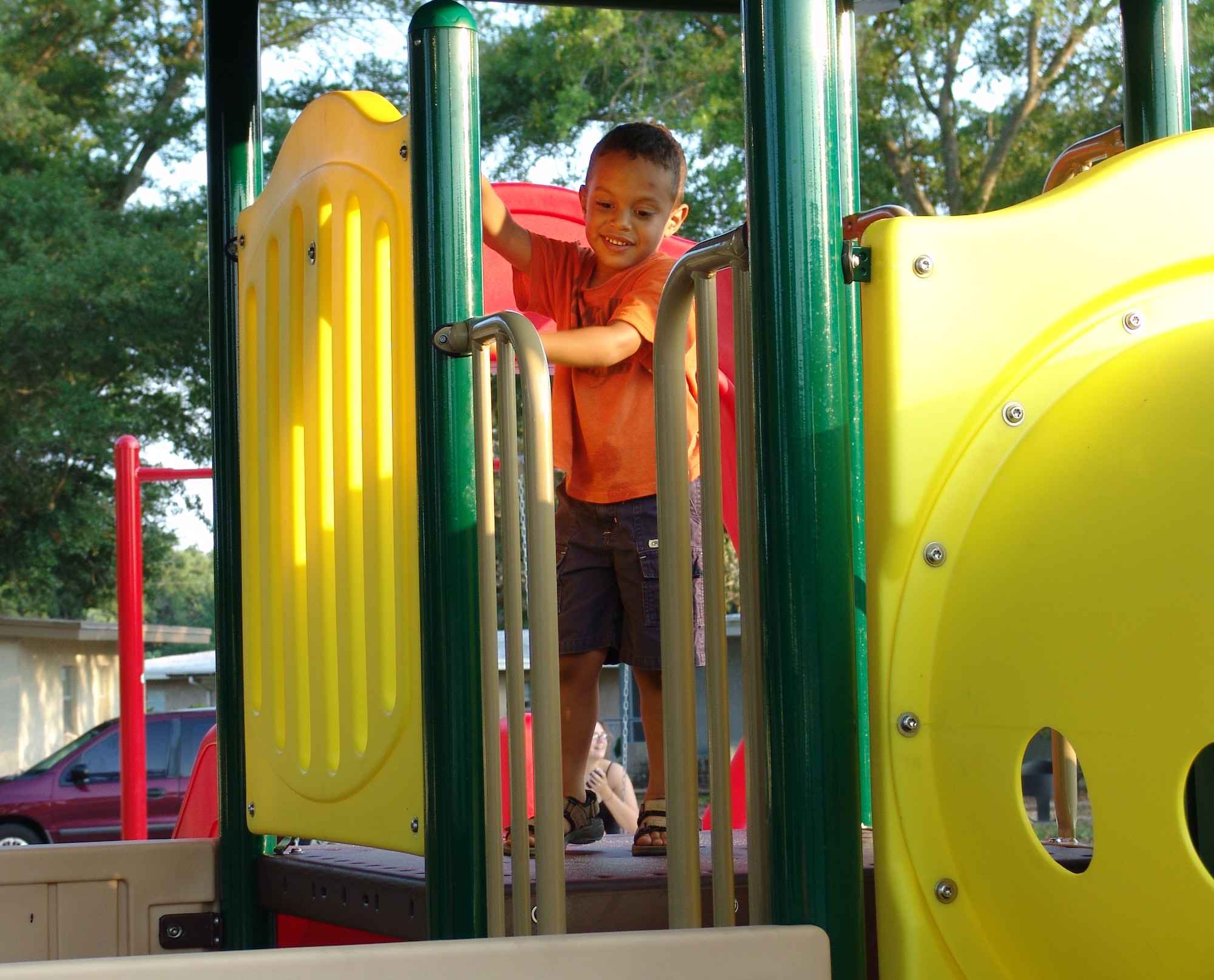 Matt Lambert enjoys climbing on the new equipment on Chinquapin Drive.  Three new playgrounds are now open for children living in base housing. (USAF photo/Lois Walsh)                        