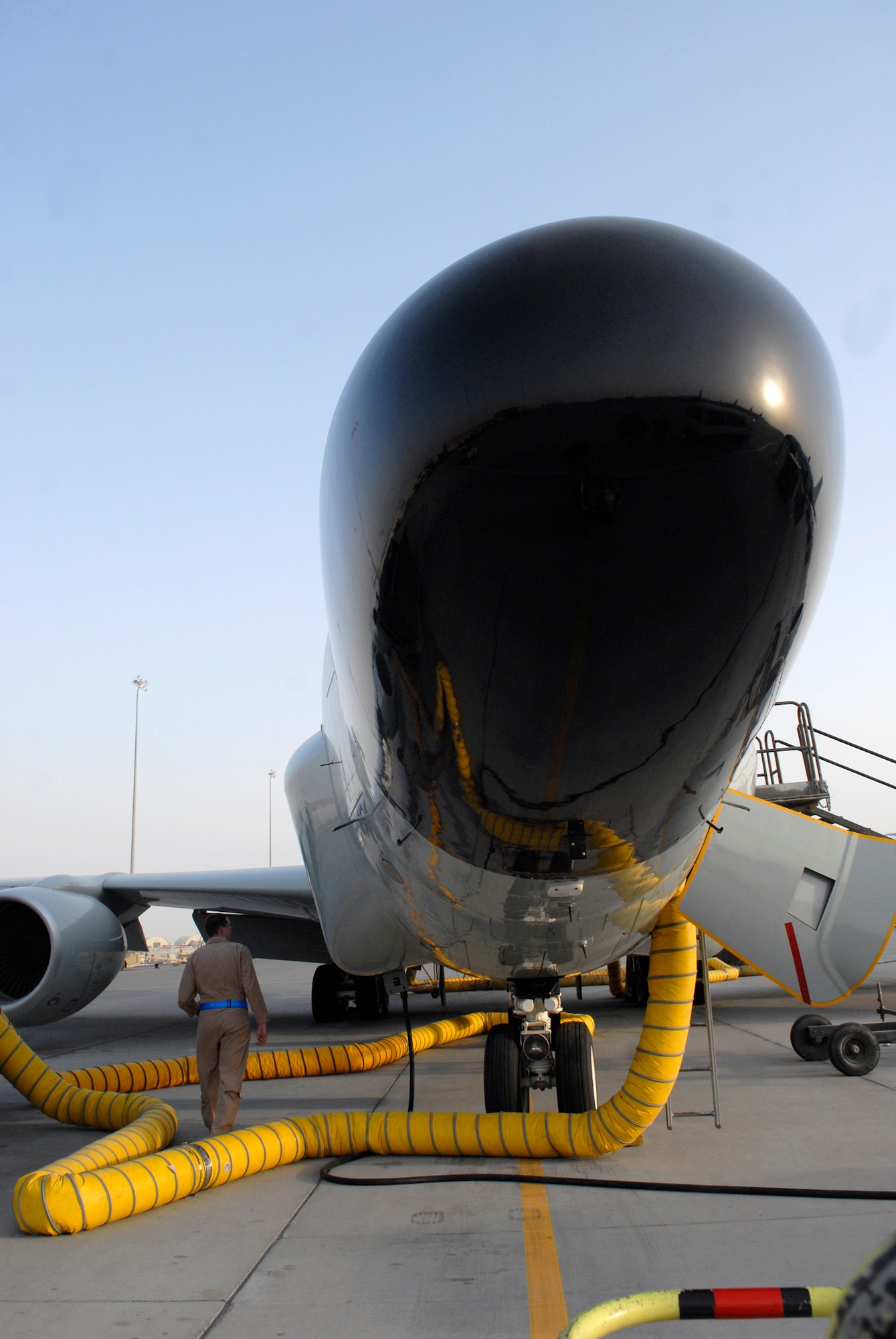 1st Lt. Cary McCreary, 763rd Expeditionary Reconnaissance Squadron electronic warfare officer, walks around the RC-135 Rivet Joint aircraft for pre-flight checks, June 24, 2009, at an undisclosed location in Southwest Asia.  The Airmen on board collect intelligence and analyze data for mission support in the U.S. Central Command's area of responsibility.  Lieutenant McCreary hails from Ramona, Calif. and is deployed from Offutt Air Force Base, Neb., in support of Operation Iraqi and Enduring Freedom and Combined Joint Task Force - Horn of Africa.  (U.S. Air Force photo/Senior Airman Andrew Satran/released)