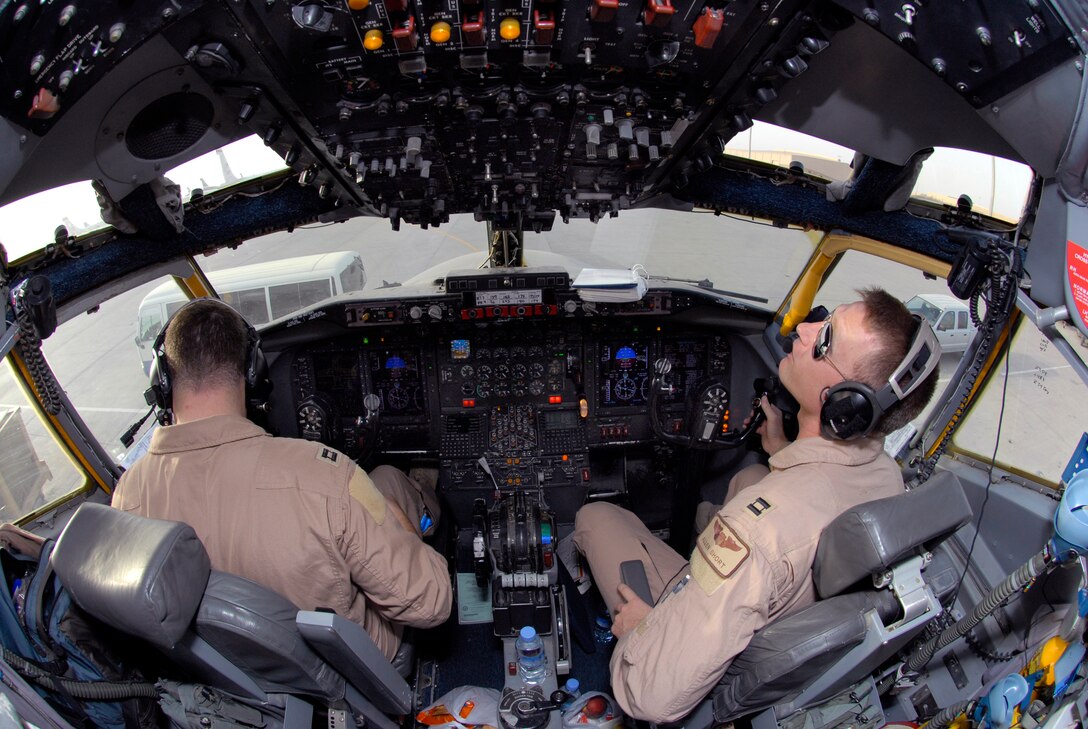 Captain Keegan McConaughey, a 763rd Expeditionary Reconnaissance Squadron (ERS) Aircraft Commander, and Captain Allen Short, 763rd ERS Co-Pilot, perform their pre-flight checks in the cockpit of an RC-135 Rivet Joint aircraft, June 24, 2009, at an undisclosed location in Southwest Asia.  The Airmen on board collect intelligence and analyze data for mission support in the U.S. Central Command's area of responsibility.  Capt. McConaughey hails from Houlton, Wis., Capt. Short hails from Chino Valley, Calif.  Both are deployed from Offutt Air Force Base, Neb. in support of Operations Iraqi and Enduring Freedom and Combined Joint Task Force - Horn of Africa.  (U.S. Air Force photo/Senior Airman Andrew Satran/released)
